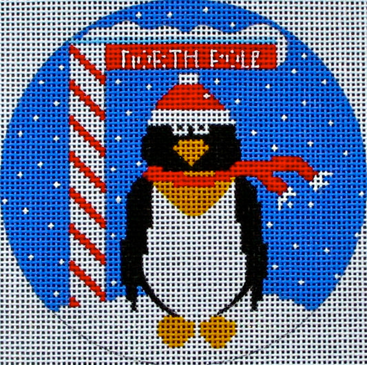 DC designs round Christmas ornament needlepoint canvas of a whimsical penguin wearing a scarf and a Santa hat at the north pole with a candy cane striped sign